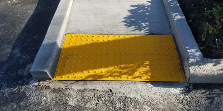 New ADA sidewalk ramp with detectable warning pad