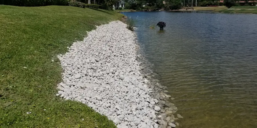Rock riprap erosion control along a lake bank